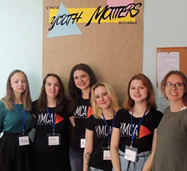 A group of young women stand together while at a YMCA in Ukraine.