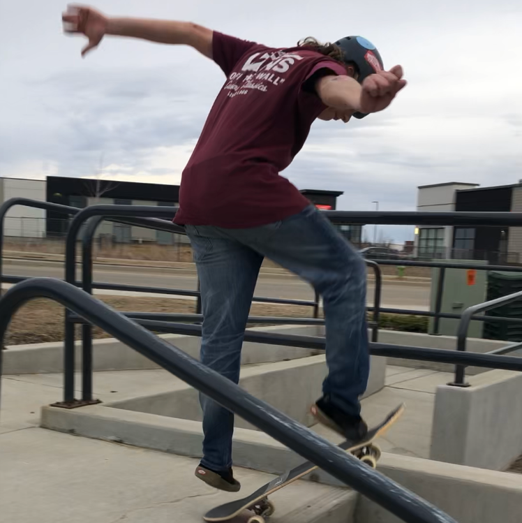 person doing skateboard trick down stair