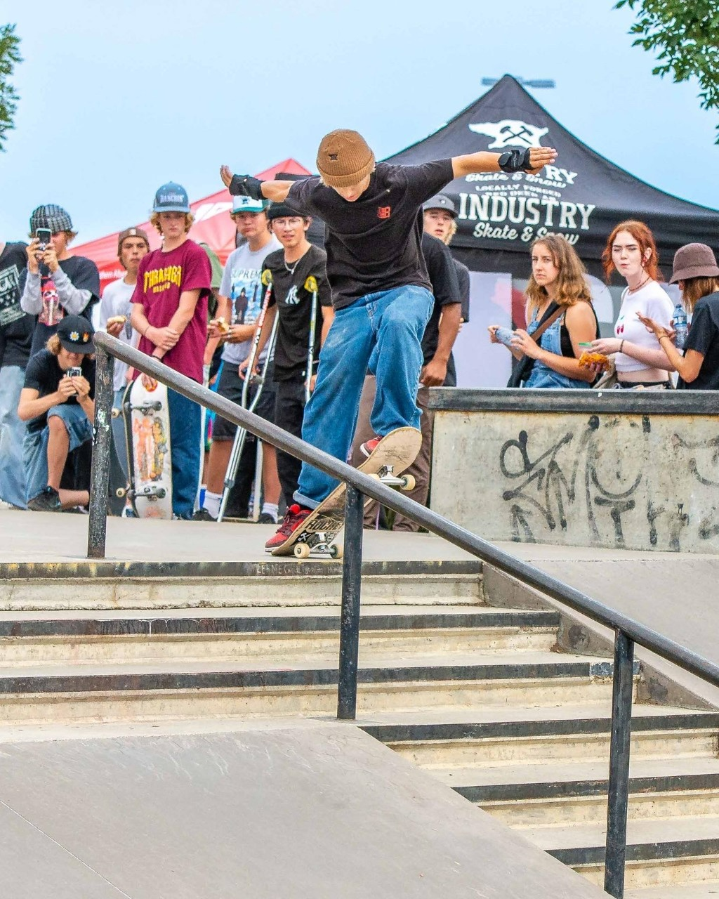 person doing skateboard trick in front of crowd