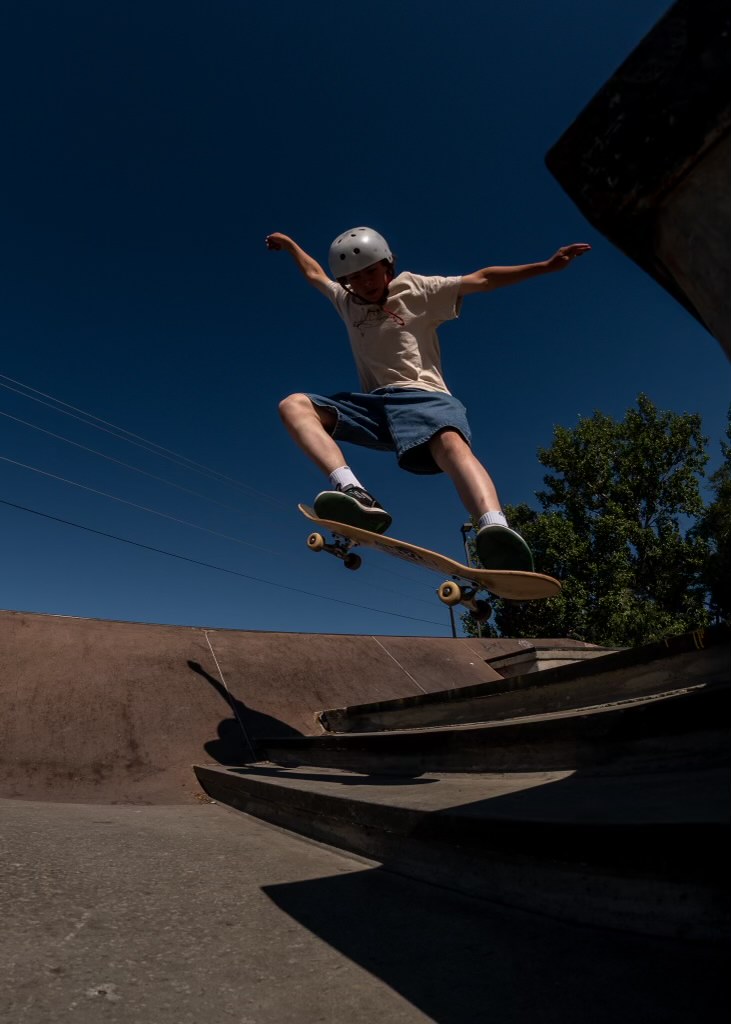 person doing skateboard trick down stairs