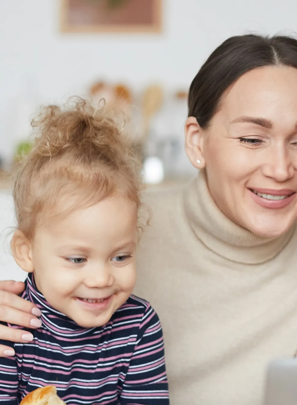 Portrait of smiling mixed race family using laptop together while using a computer.