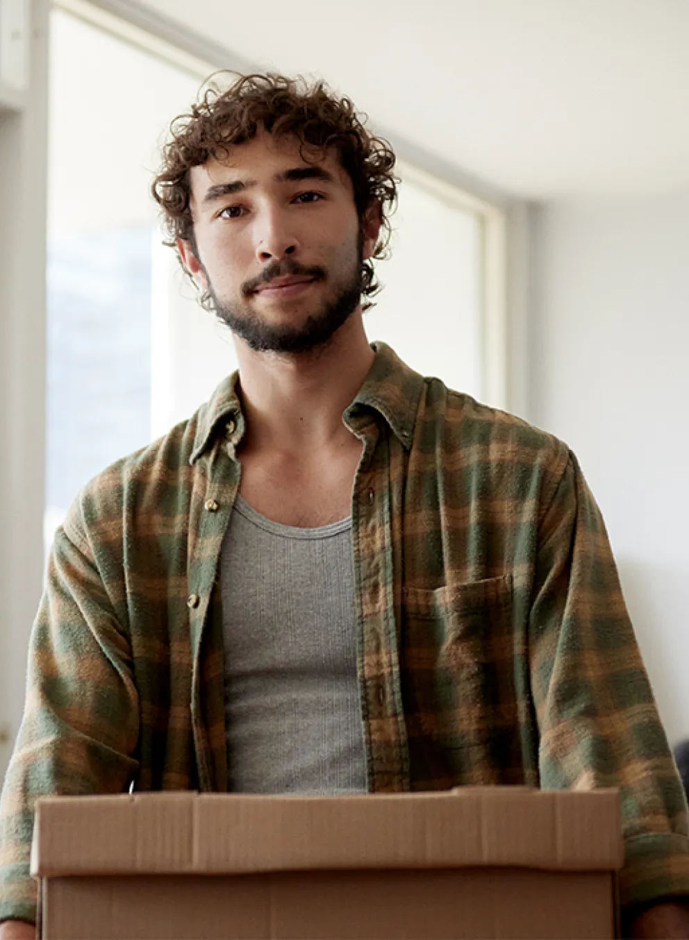 man carrying a box - nc housing web banner