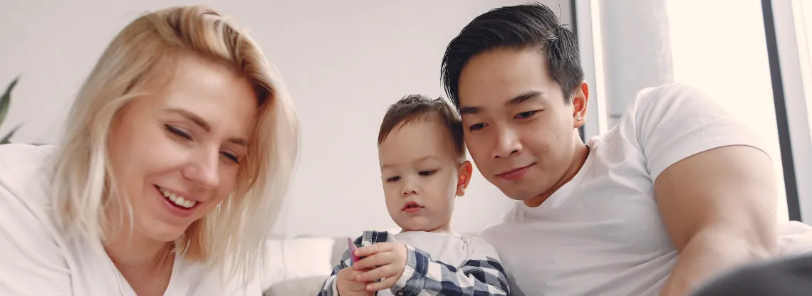A family does arts and crafts on the floor of their livingroom.