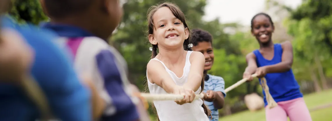 Kids playing tug of war during a Day Camp